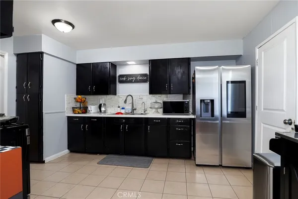 a kitchen with stainless steel appliances granite countertop a refrigerator and a sink