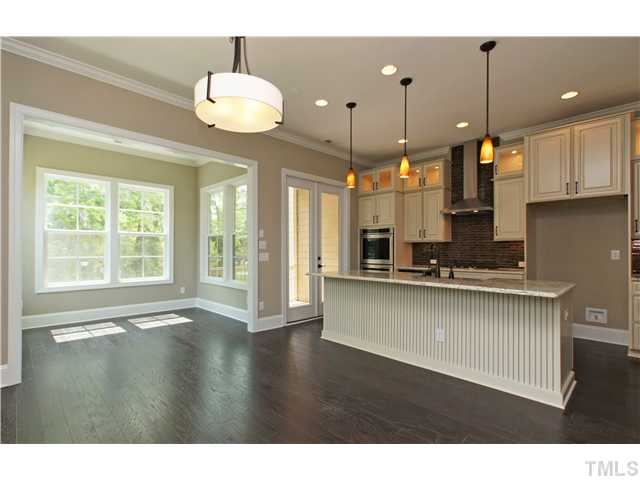 102 Penley Circle Raleigh, NC 27609 - Photo 8 of 24 a kitchen with stainless steel appliances granite countertop a stove a sink a window and chairs