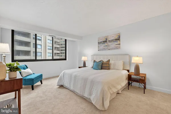 a bathroom with a granite countertop sink a toilet and a mirror