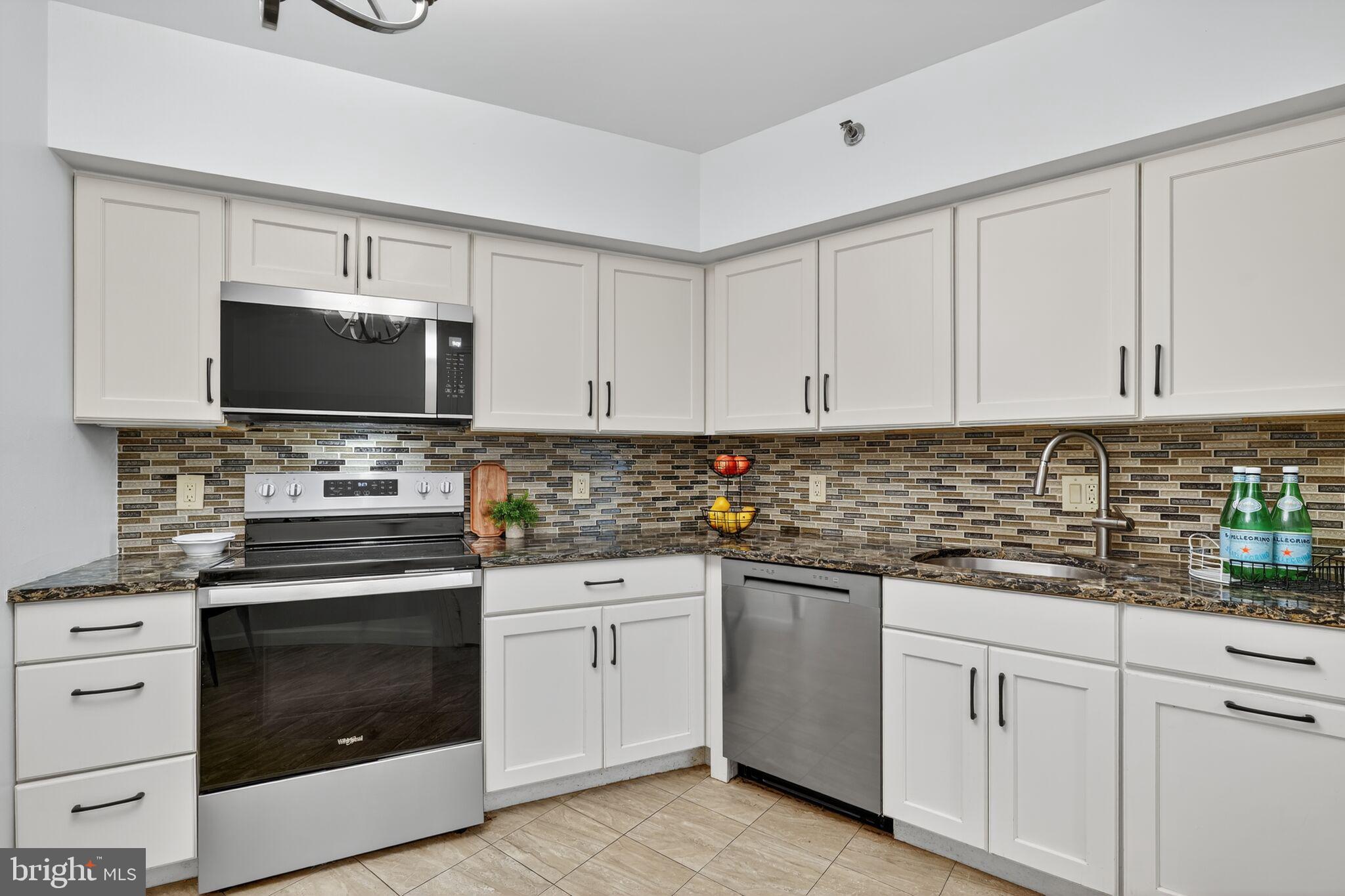4550 North Park Avenue, Unit 814 Chevy Chase, MD 20815 - Photo 9 of 25 a kitchen with white cabinets appliances and sink