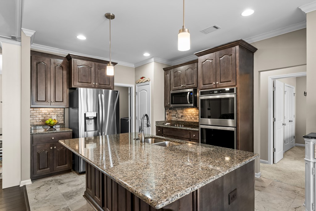 96 Morgan Trail Ellijay, GA 30536 - Photo 27 of 48 a kitchen with stainless steel appliances granite countertop a sink refrigerator and cabinets