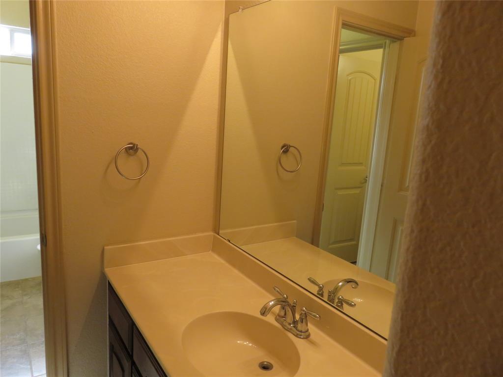 1122 Walter Stephenson Road Midlothian, TX 76065 - Photo 24 of 26 Vanity with integrated sink, chrome faucet, and expansive wall-mounted mirror