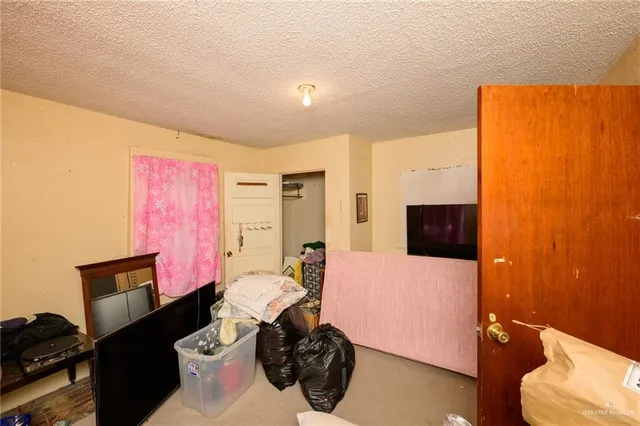 a bedroom with furniture a flat screen tv and a view of bedroom