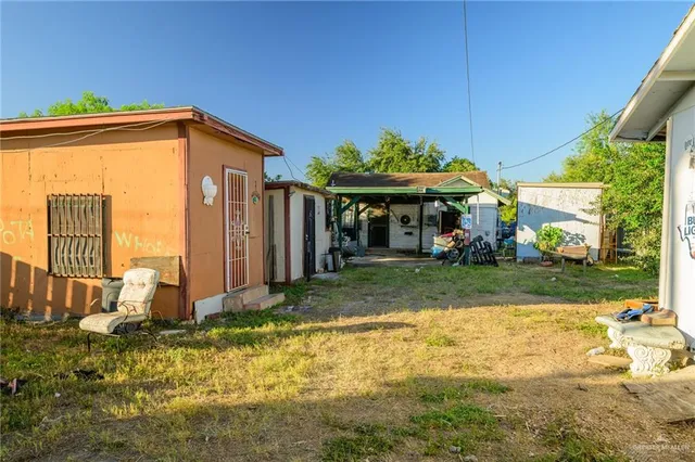 a view of a house with backyard and sitting area