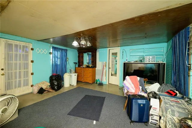 a bedroom with furniture and a flat screen tv
