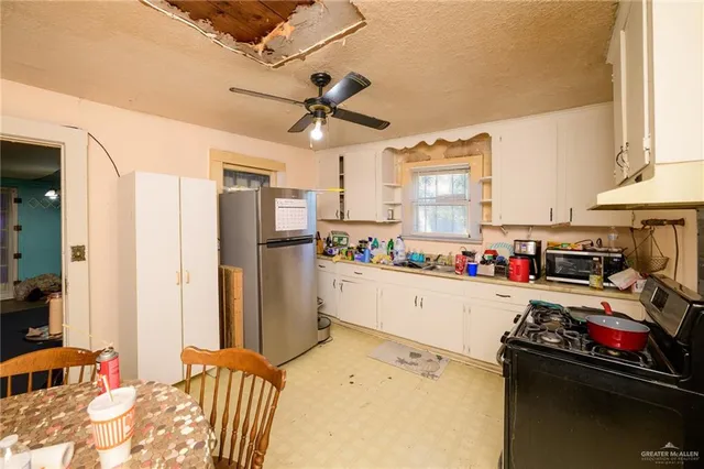 a kitchen with a refrigerator and a stove