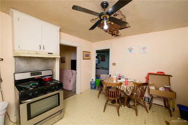 a kitchen with stainless steel appliances kitchen island granite countertop a stove and a refrigerator