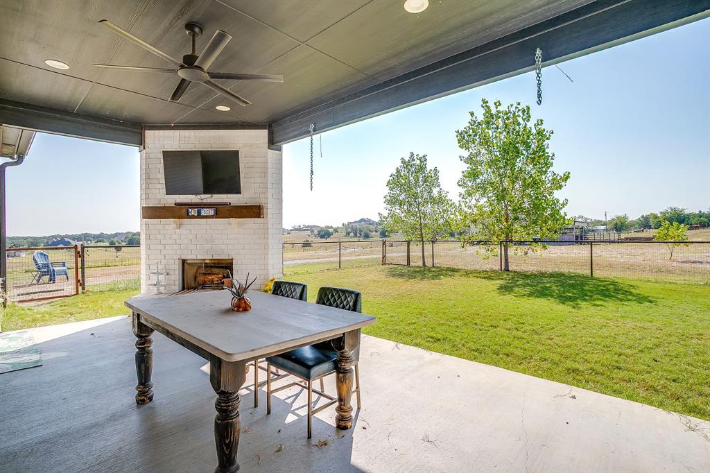 116 Aviara Ridge Road Poolville, TX 76487 - Photo 28 of 38 a view of a patio with a table and chairs