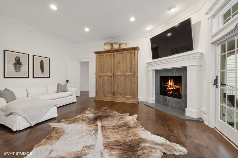 383 West County Line Road Barrington Hills, IL 60010 - Photo 30 of 75 a living room with furniture a fireplace and a flat screen tv