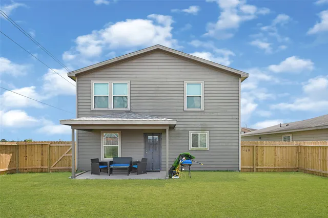 a view of a house with a yard and sitting area