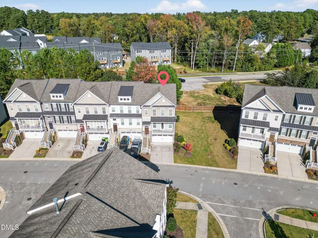 an aerial view of a house with a garden and mountain view in back