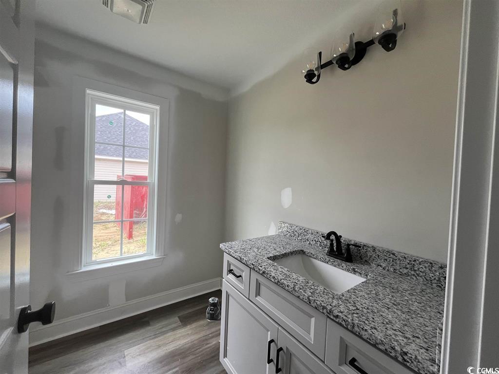 8187 Kerl Road Aynor, SC 29511 - Photo 10 of 14 Bathroom with hardwood / wood-style floors and van