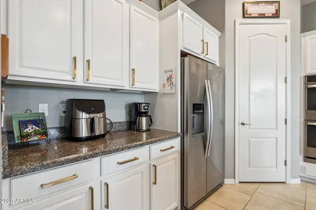 a kitchen with stainless steel appliances granite countertop a stove and a refrigerator