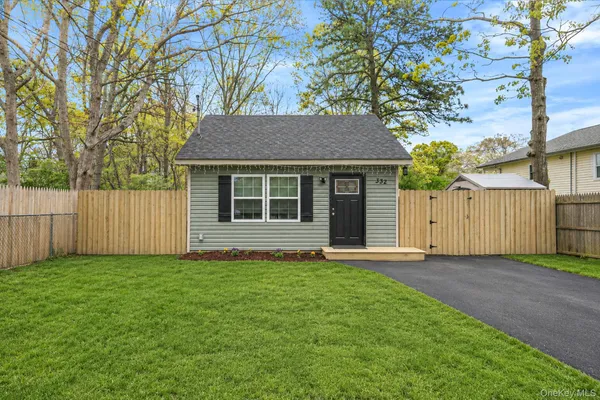 a house that has a tree in front of it