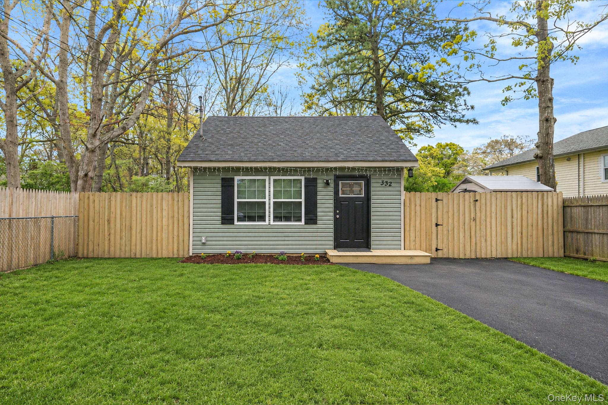 332 Commack Road Shirley, NY 11967 - Photo 1 of 25 a house that has a tree in front of it