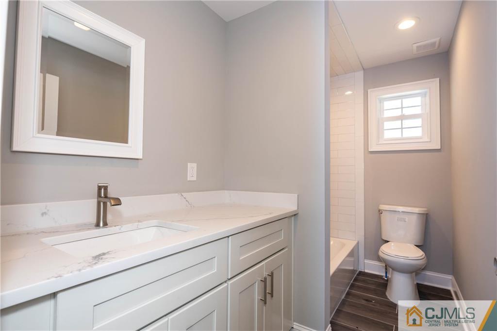 48 Brookville Road Edison, NJ 08817 - Photo 25 of 28 a bathroom with a sink toilet and mirror