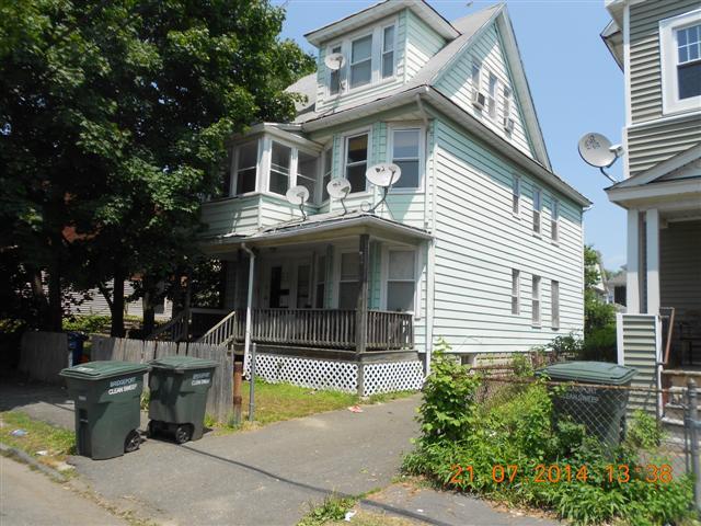 578 Carroll Avenue Bridgeport, CT 06607 - Photo 1 of 1 a view of a white house with large windows and a small yard