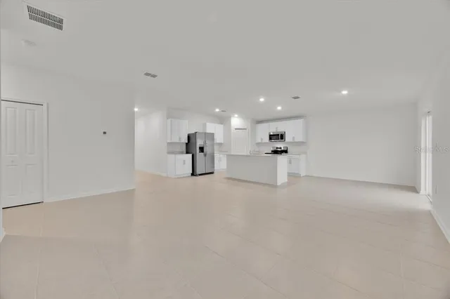 a view of large windows with white kitchen