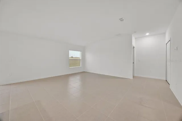 a view of an empty room and a window