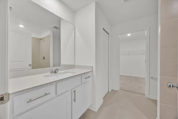a bathroom with a granite countertop sink two mirror and a