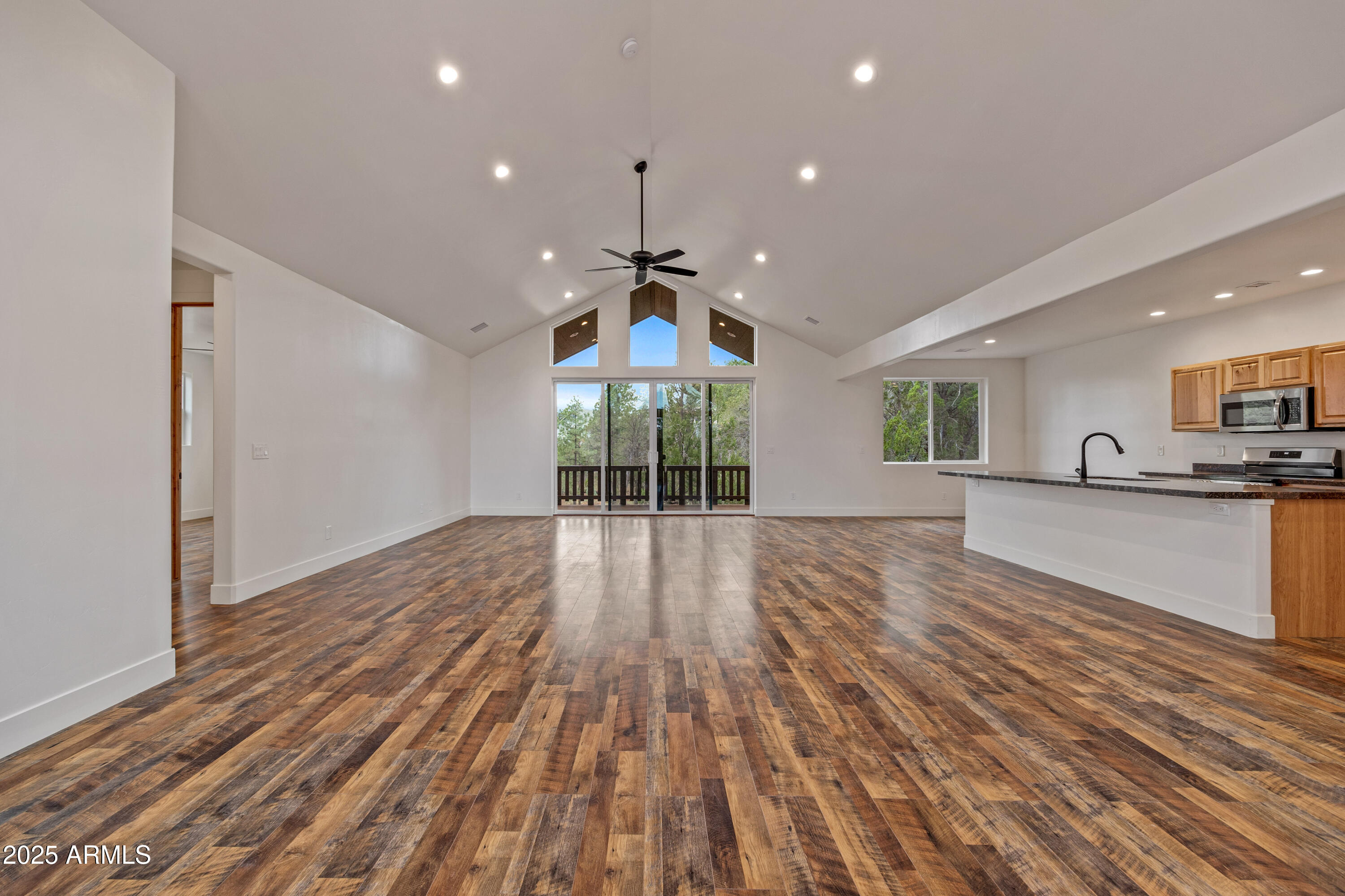 2759 Panther Circle Overgaard, AZ 85933 - Photo 4 of 11 a view of an empty room with wooden floor and a window