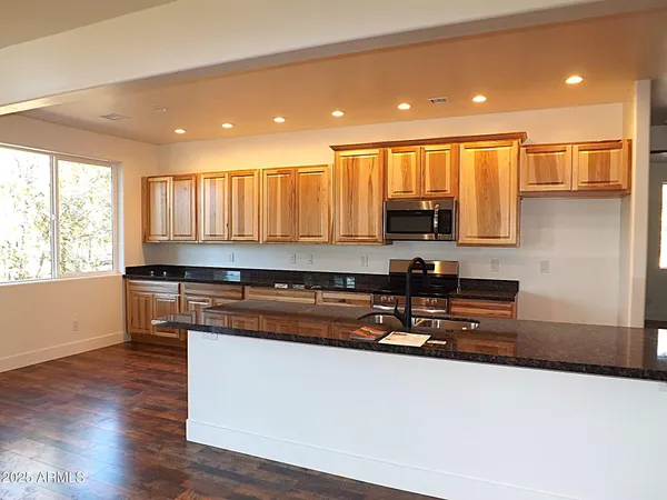 a kitchen with a refrigerator and a microwave