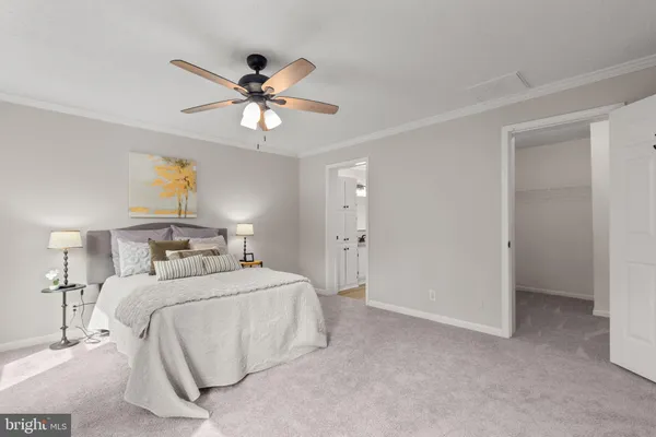 a en suite bathroom with a granite countertop sink and a mirror