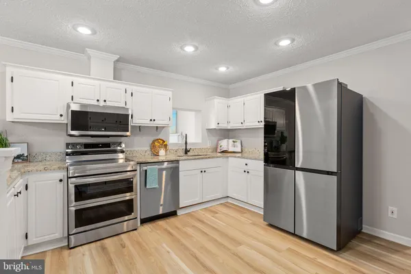 a kitchen with a refrigerator stove and microwave