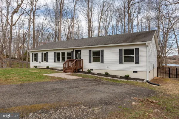 a view of a house with backyard porch and sitting area