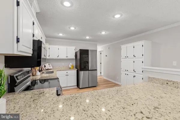 a large white kitchen with white cabinets