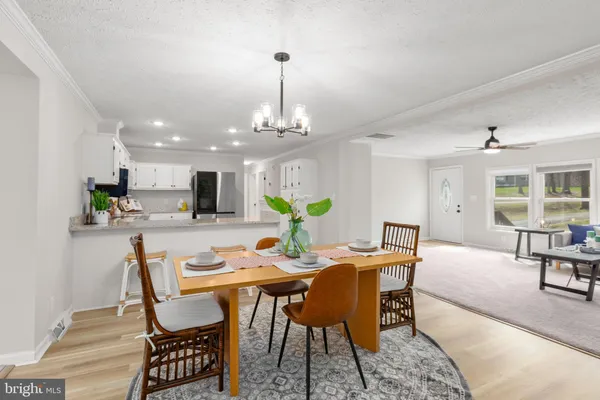 a view of a dining room with furniture and chandelier