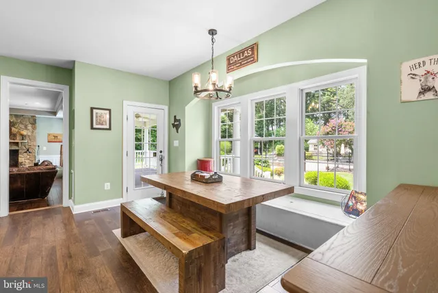 a view of a dining room with furniture wooden floor and chandelier