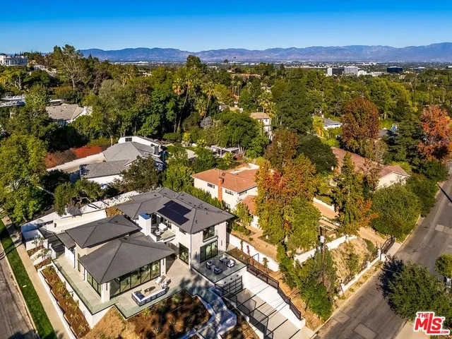 an aerial view of residential house with outdoor space and swimming pool