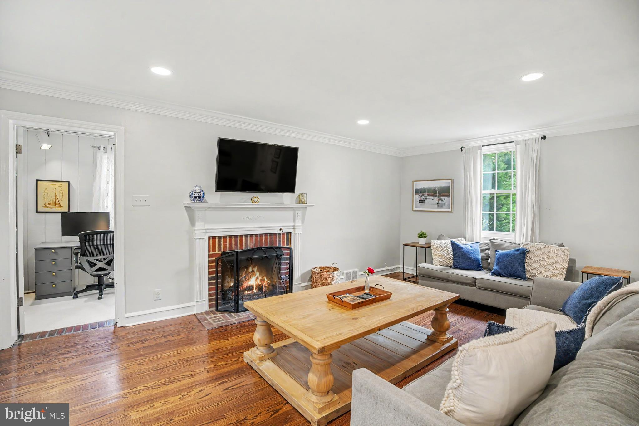 235 Hopkins Road Haddonfield, NJ 08033 - Photo 15 of 47 a living room with furniture a fireplace and a flat screen tv