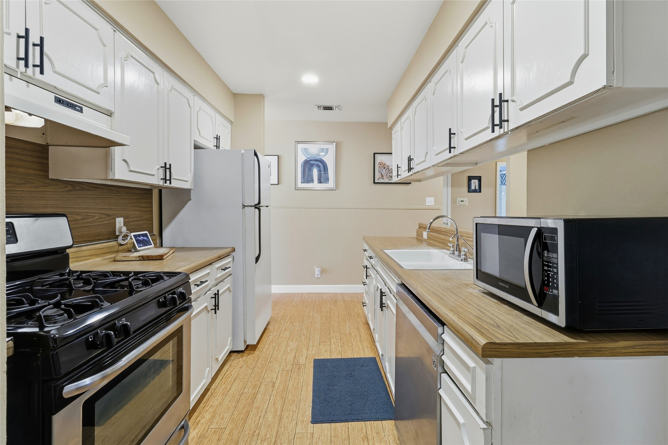 505 Lightsey Road Austin, TX 78704 - Photo 14 of 36 a kitchen with stainless steel appliances granite countertop a stove and a sink