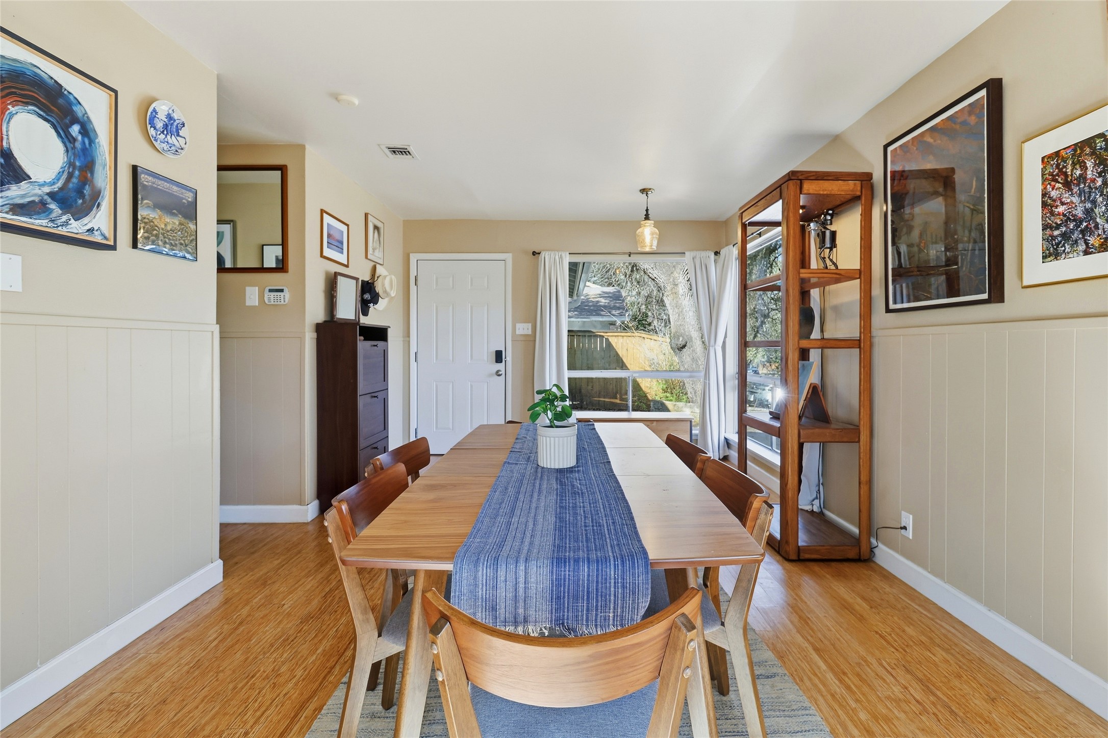 505 Lightsey Road Austin, TX 78704 - Photo 15 of 36 Dining area with wainscoting and light wood finished floors
