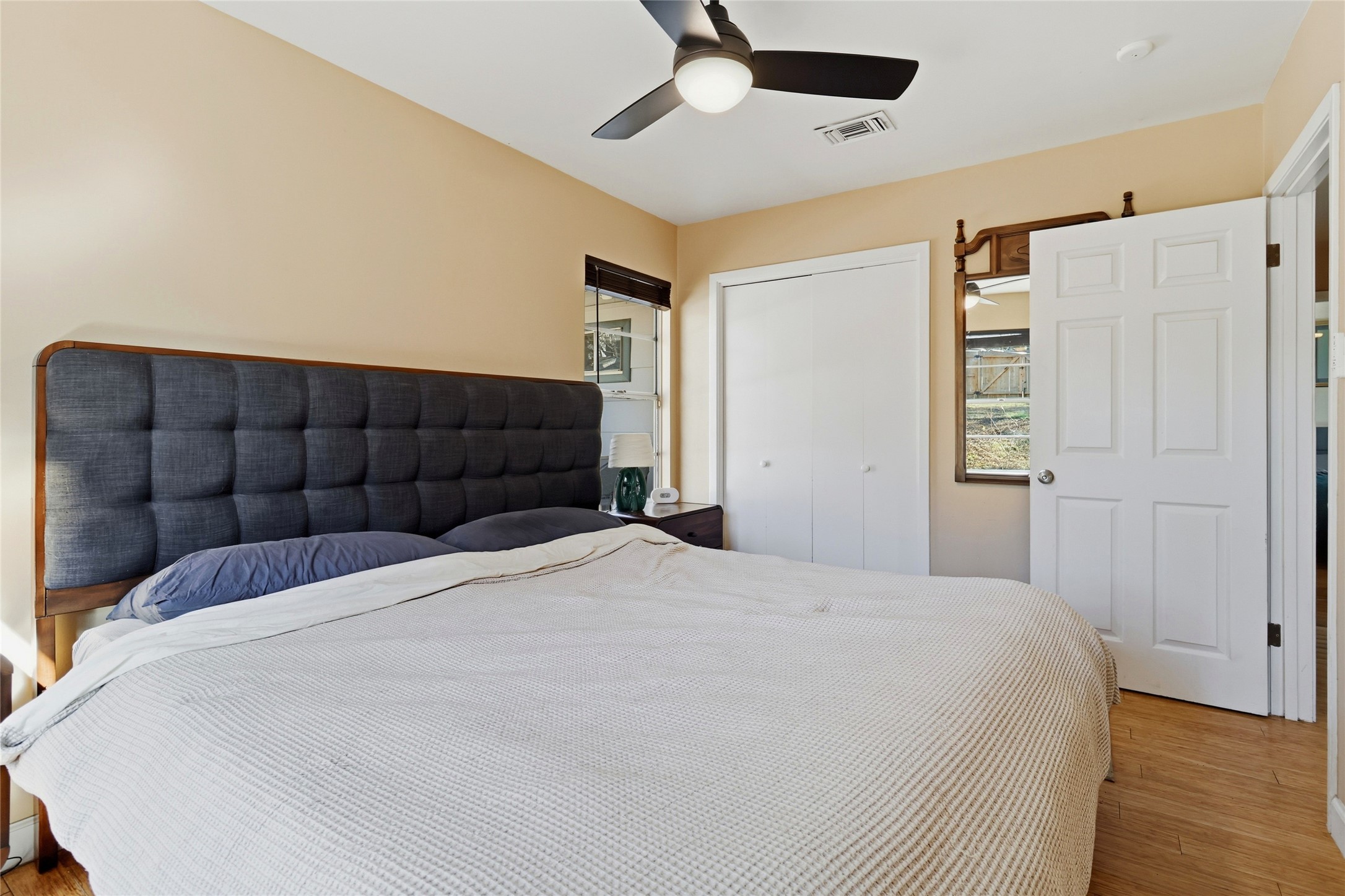 505 Lightsey Road Austin, TX 78704 - Photo 17 of 36 Bedroom with wood finished floors, a closet, and a ceiling fan