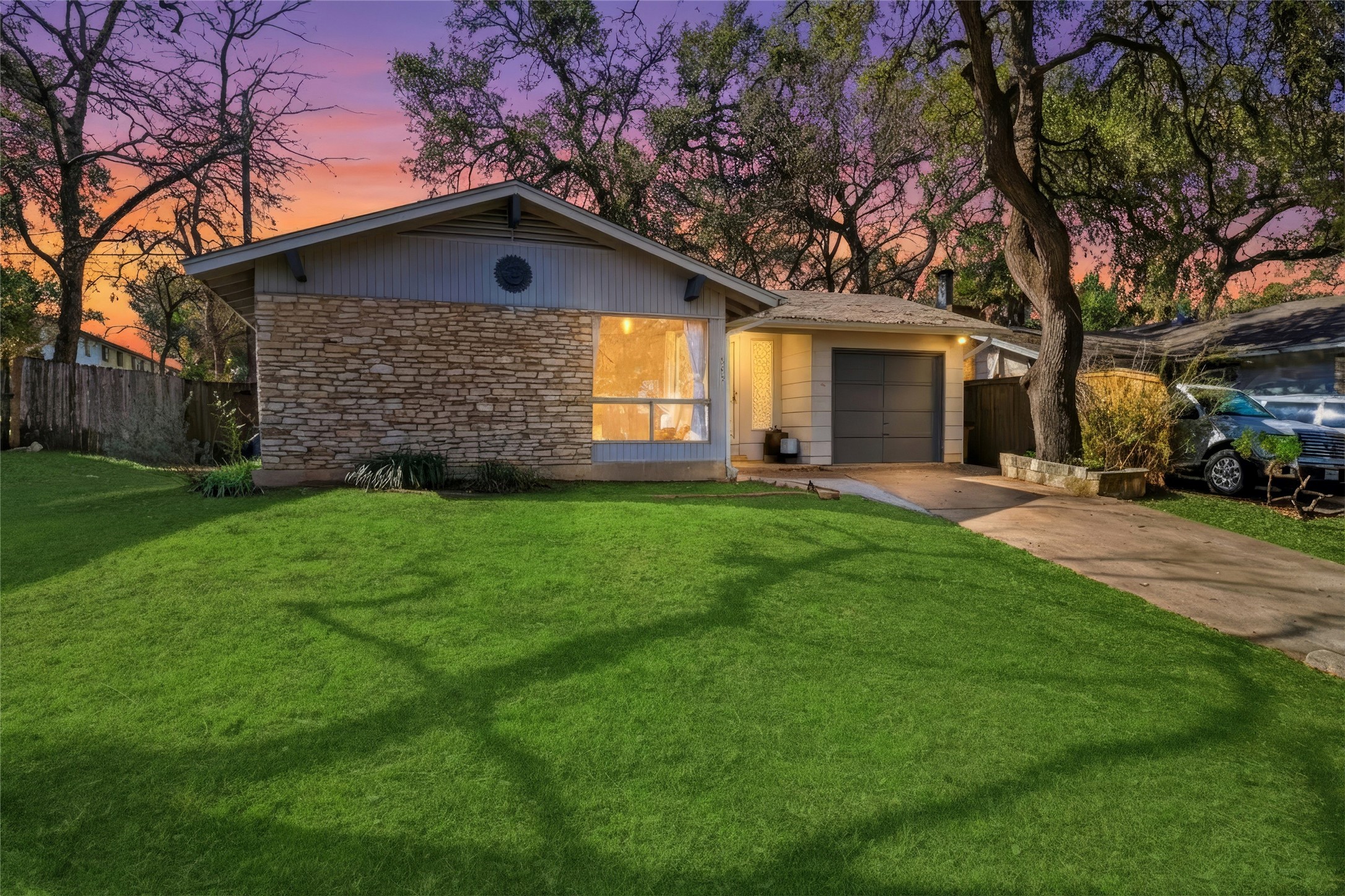 505 Lightsey Road Austin, TX 78704 - Photo 2 of 36 View of front facade featuring concrete driveway, a garage, and stone siding