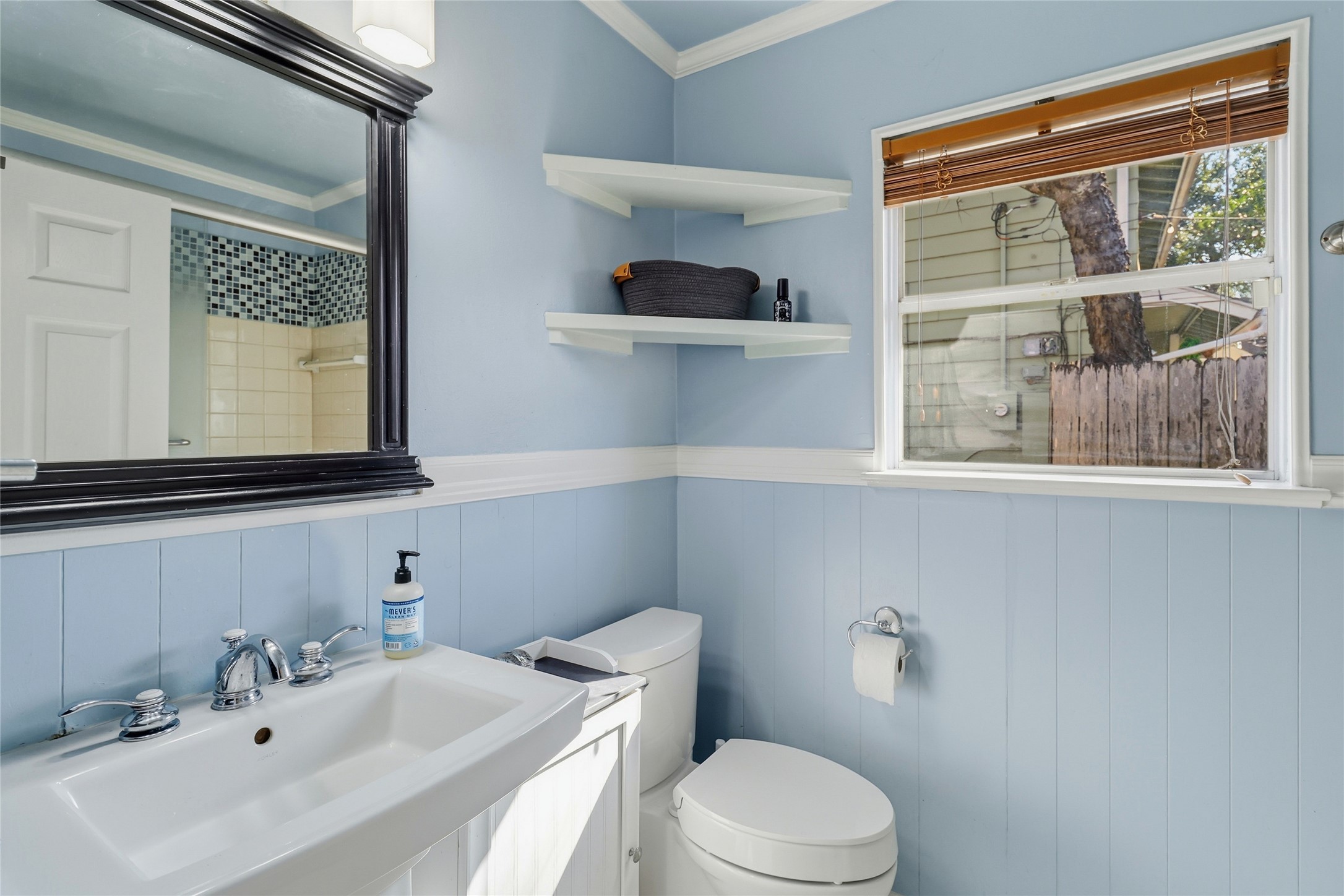 505 Lightsey Road Austin, TX 78704 - Photo 22 of 36 Full bathroom with crown molding, a wainscoted wall, vanity, and a shower