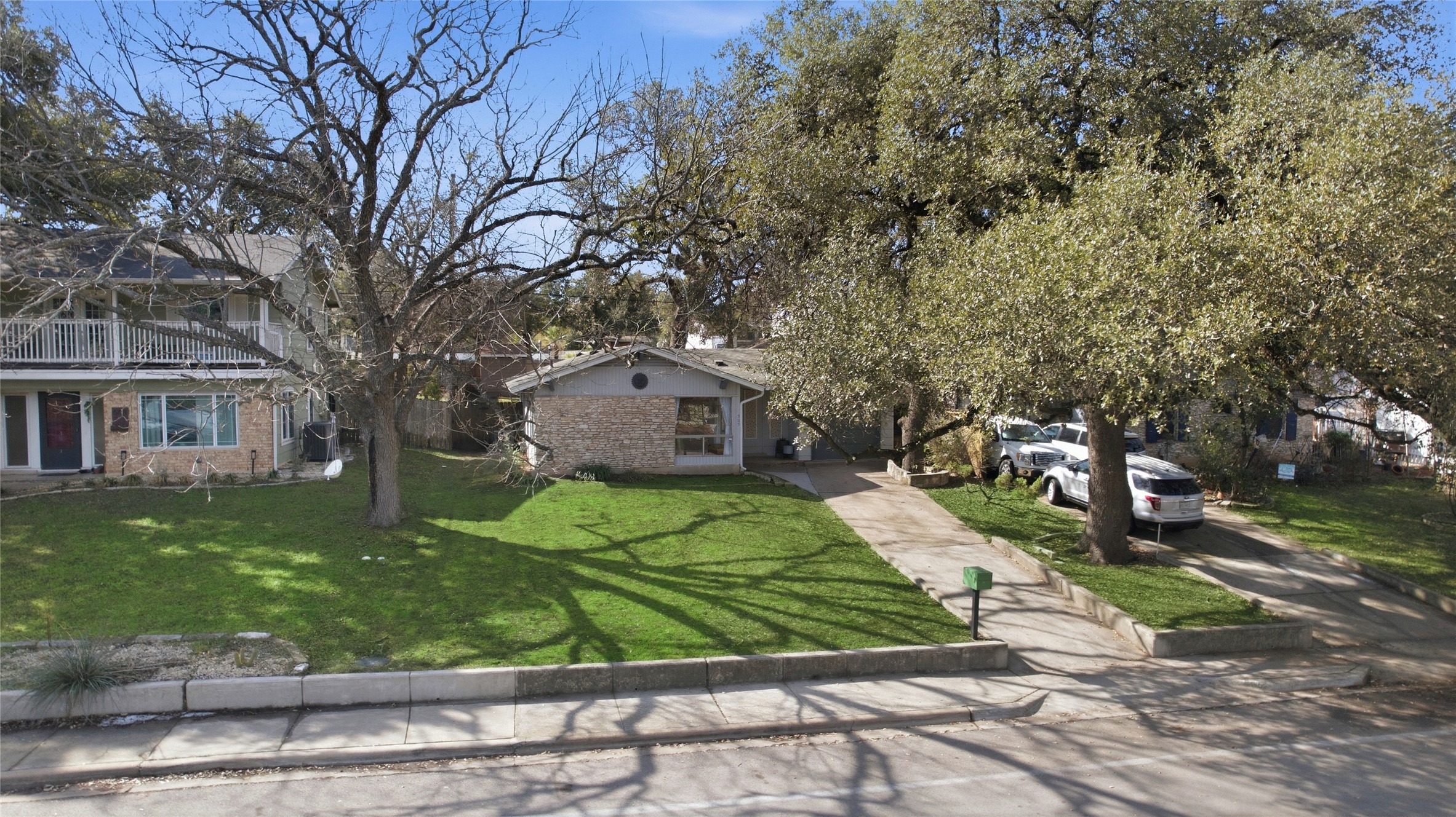 505 Lightsey Road Austin, TX 78704 - Photo 34 of 36 View of front facade with a front yard, brick siding, and driveway