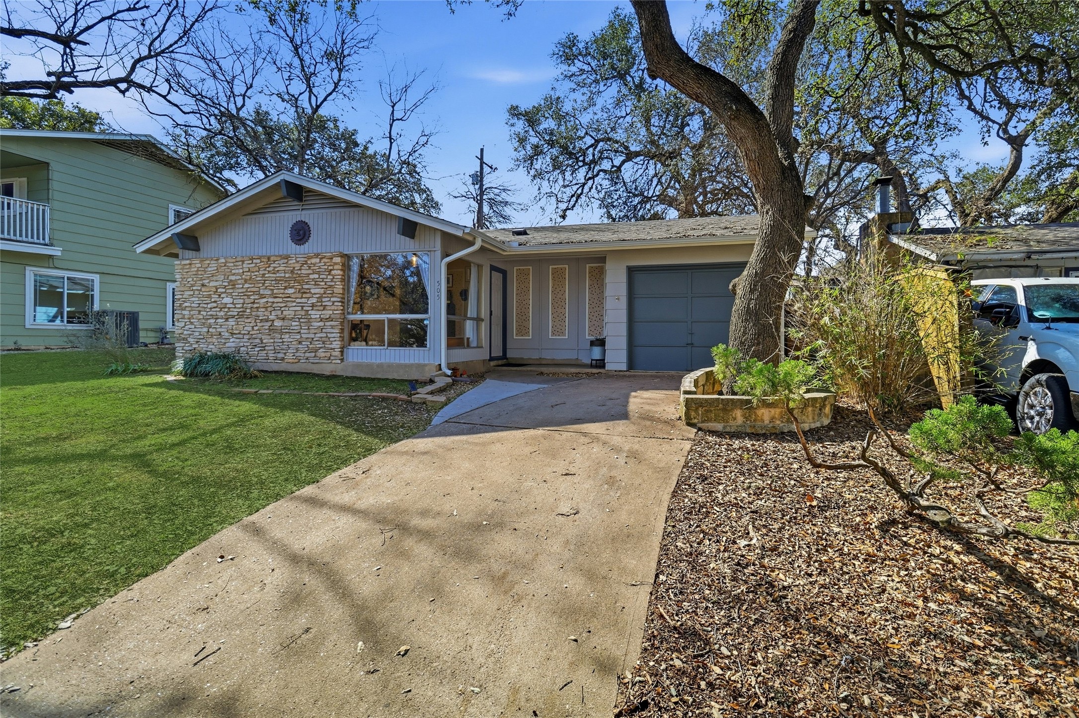 505 Lightsey Road Austin, TX 78704 - Photo 4 of 36 a front view of a house with a garden and yard