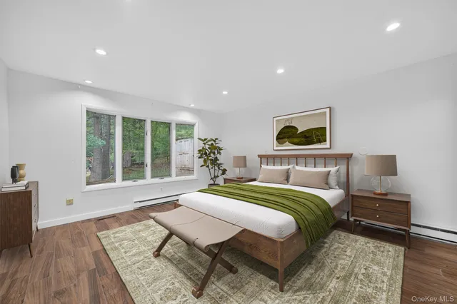 a bedroom with a bed and a large window