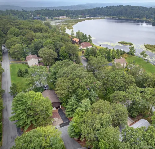 an aerial view of a houses with a lake view