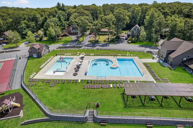 a view of a lake with lawn chairs