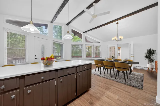 a kitchen with stove a dining table and chairs with wooden floor