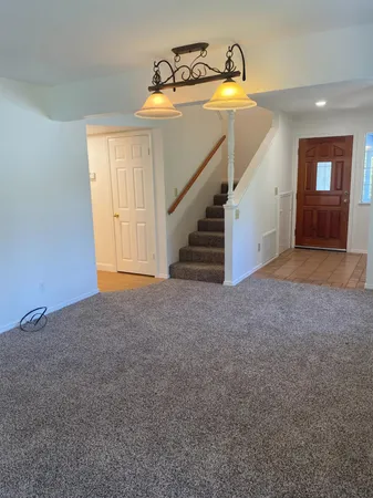 a view of an empty room and stairs