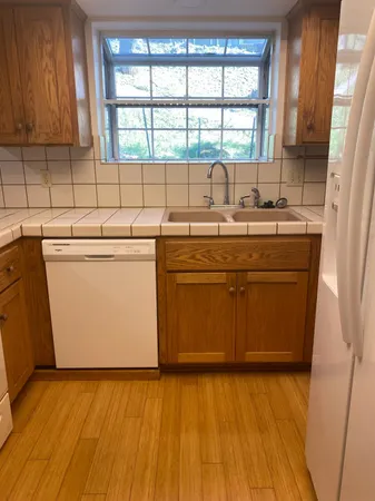 a bathroom with a toilet a sink and a window