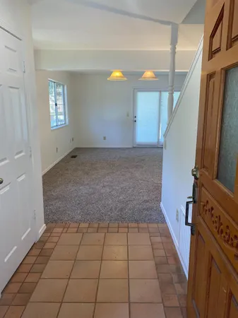 a kitchen with a sink a stove a refrigerator and a window