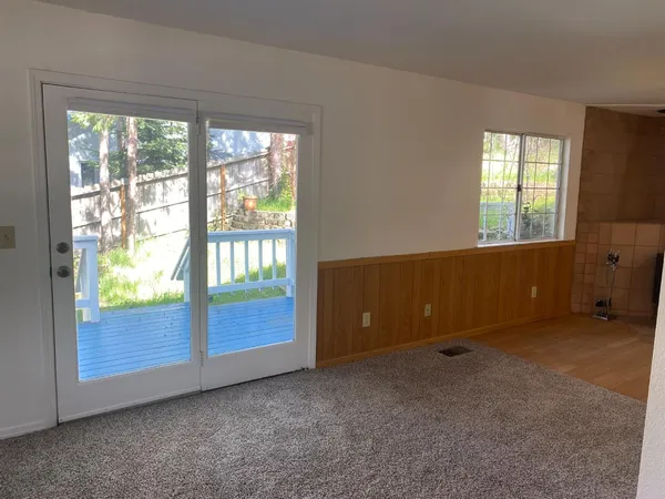 a view of a room with wooden floor and cabinet