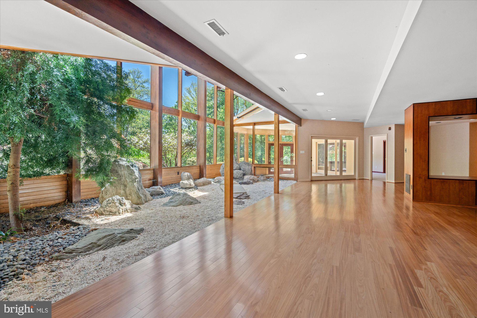 7211 Brickyard Road Potomac, MD 20854 - Photo 28 of 46 a view of empty room with wooden floor and windows